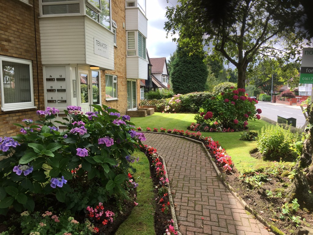 Garden maintenance done in Ten Acre Court, featuring planted flowers, grass turf and trees.