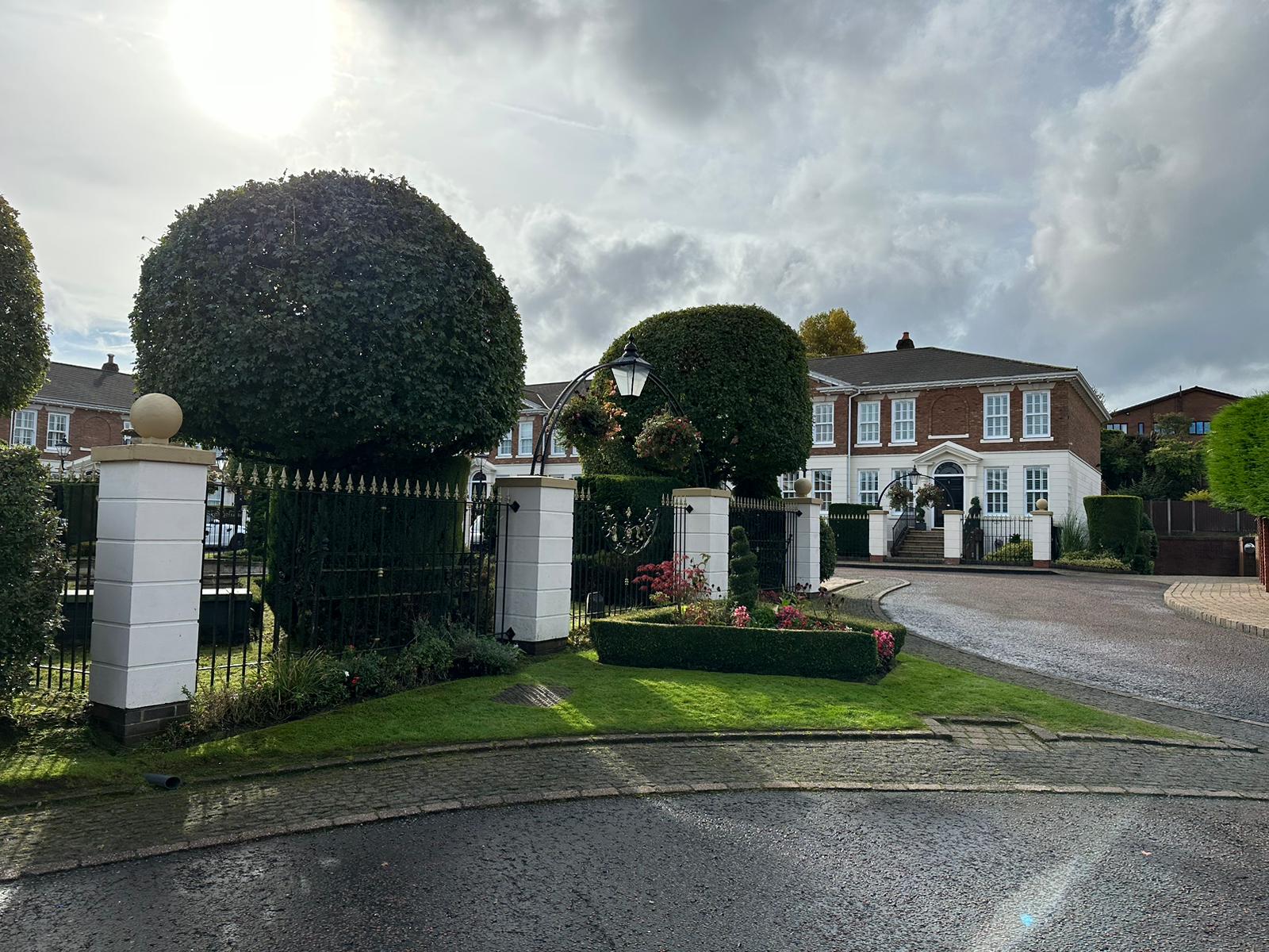 An image of garden maintenance work done, with a review over the top from a customer in Whitefield.